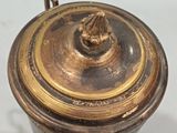brass plated coffee pot with lid on a white surface