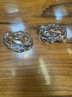 two glass ashtrays on a wooden table