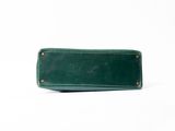green leather pencil case with brass studs on a white background