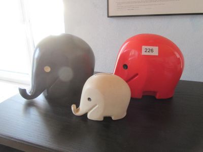 trois figurines d'éléphants posées les unes à côté des autres sur une table