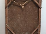 a picture of a wooden clock on display in a glass case