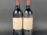 two bottles of wine sitting next to each other on a table