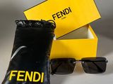 fendi sunglasses in a black bag and a pair of black sunglasses