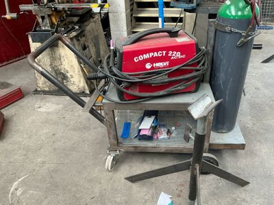 un extincteur rouge posé sur un chariot dans un garage