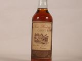 an image of a bottle of whiskey sitting on a white surface