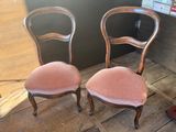 two chairs sitting next to each other on a wooden floor