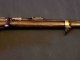 a close up of a rifle mounted on a wall near a wall