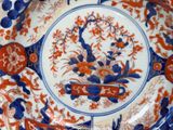 a blue and orange plate with a flower design on it