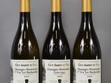 three bottles of wine sitting on top of a table next to each other