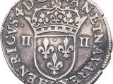 a close up of a coin with a crown on it