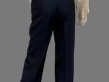 the back of a woman ' s blouse and pants are shown on a mannequin mannequin