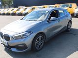 a silver bmw car parked in a parking lot
