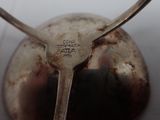 a spoon that is sitting on top of a silver object