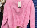 a rack of clothes and a hat in a store