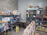 a room with a lot of tools and supplies on the shelves