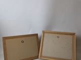 two wooden frames with a white background and a white wall