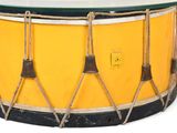yellow and black drum sitting on top of a glass top table