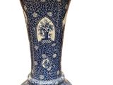 a blue and white vase sitting on a white surface