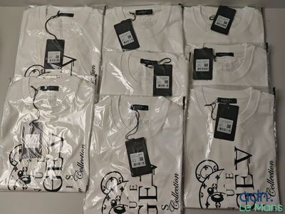 several white t - shirts with black and white designs are on a table