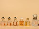bottles of perfume are lined up in a row on a table