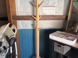 a coat rack and a fan in the corner of a room