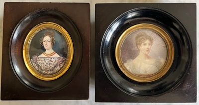 two framed portraits of a woman and a man in formal dress