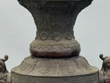 a large vase that has two elephants on it