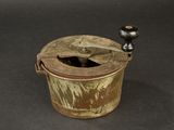 an old wooden bucket with a metal handle on a table
