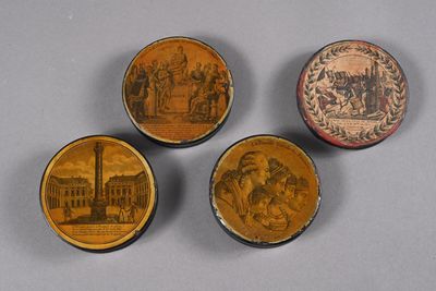 three small wooden boxes with pictures of people on them on a table