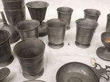 many cups and bowls that are on a table