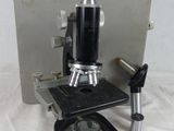 a close up of a microscope on a white surface