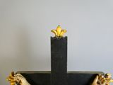 a cross made out of wood with gold decorations on it