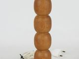 an image of a wooden table lamp with a cord plugged into it