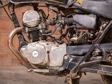 a close up of a motorcycle parked in front of a brick wall