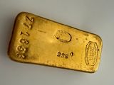 a close up of a gold bar on a white surface