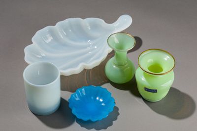 several pieces of glass sitting on top of a table next to each other