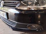 a close up of a car ' s headlights on a street