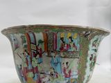 a bowl with a painting on it sitting on a white surface