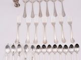 a lot of silver spoons and forks on the table