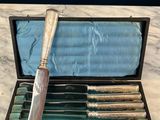 an image of a set of six knives in a case