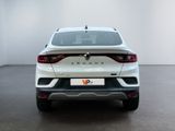 the rear end of a white suv parked in a white room