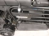 a close up of a black motorcycle with a basket on the back of it