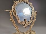 a mirror that is sitting on a stand on a table