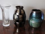 three vases sitting on a table next to each other