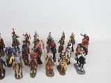 a lot of figurines that are on a white surface