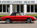 a red convertible car parked in front of a building