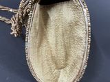 a close up of a gold purse with a chain around it