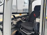 a white truck with a black seat in the back of it