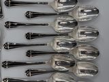 a lot of silver spoons and spoons on a table