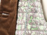 a close up of a quilted blanket with a jacket on it